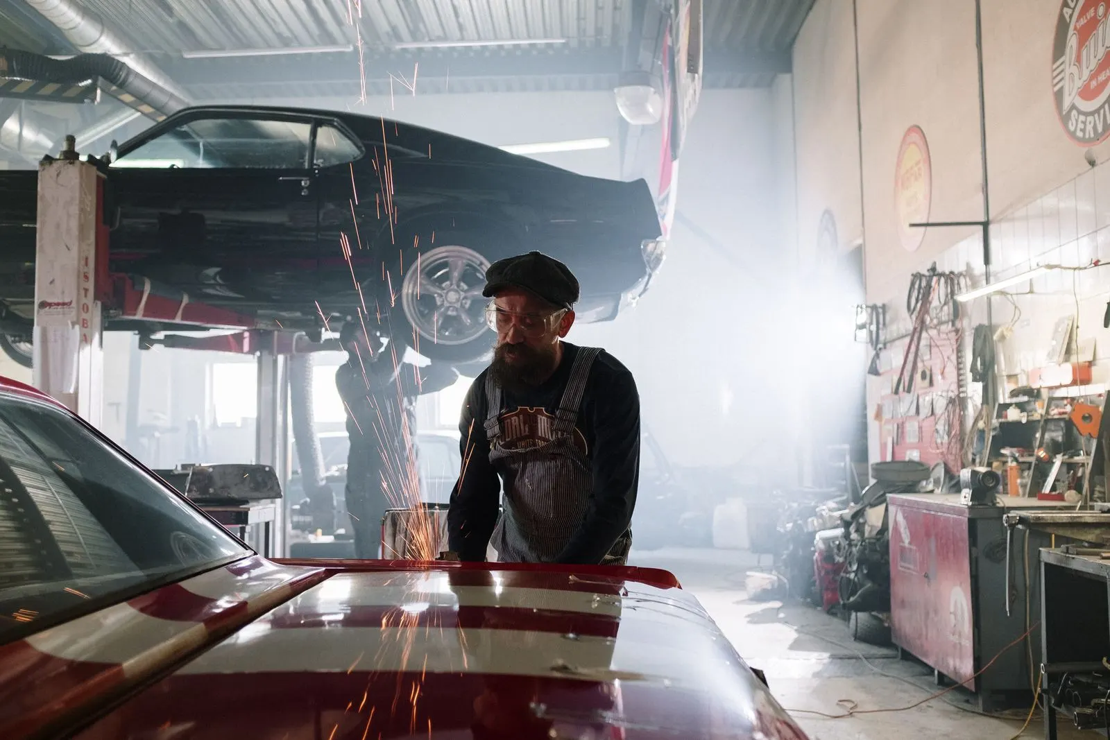 A technician leaning into an open engine bay